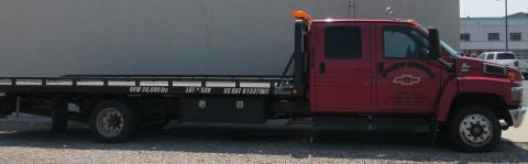 Image of a tow truck parked in the parking lot of Droubay Chevrolet dealership